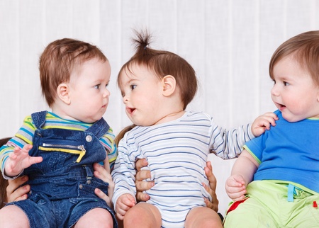 Three babies communicatingの写真素材