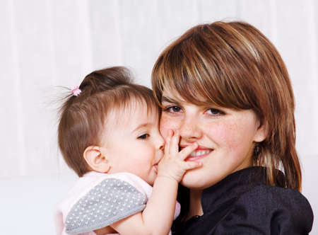 Portrait of baby girl embracing her mother
