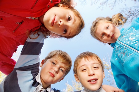 Group of embracing school aged kidsの写真素材