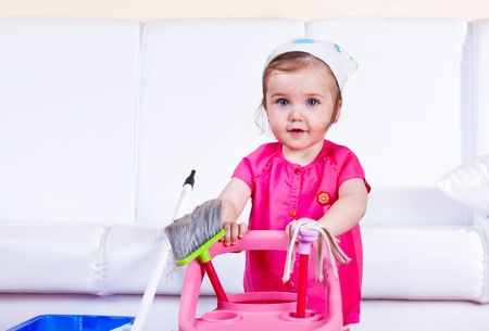 Sweet little girl doing houseworkの写真素材