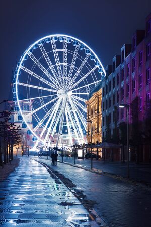 Illuminated ferry wheel in Dusseldorf, temporarily placed in the city centre at the Christmas markets timeの写真素材