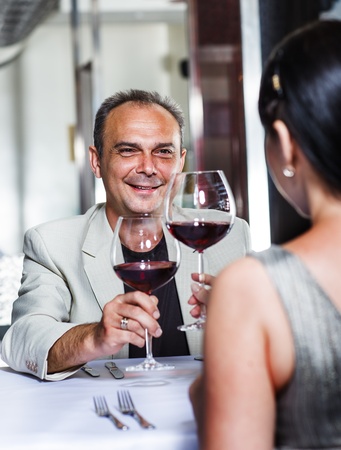 Couple celebrating in a restaurantの写真素材