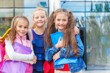 Happy friendly students with backpacks