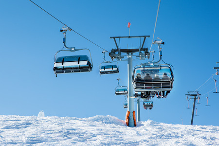 Cableway with skiers at the ski resortの写真素材