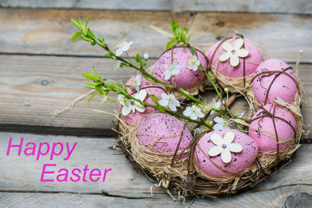 Pink eggs, symbol of Easter, lying in a nestの写真素材