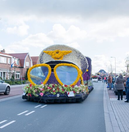 HILLEGOM, THE NETHERLANDS - APRIL 23, 2016: Moving platform with a frame made in a form of pilot sunglasses and cap. Taking part in the  traditional flowers parade "Bloemencorso".のeditorial素材