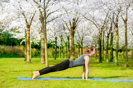 Slim woman stretching in a spring parkの写真素材
