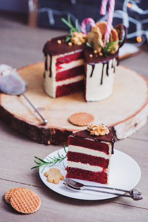 Piece of a homemade red velvet cake decorated for Christmas の写真素材