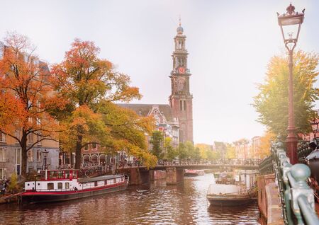 View on one of the famous Amsterdam canals and Westerkerk in autumn
