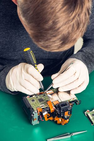 Close up hand of a technician repairing digital camera