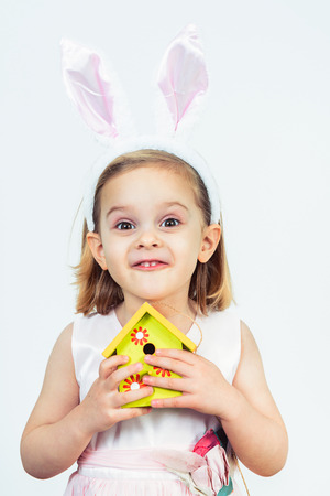 Portrait of a smiling Easter kid holding birds houseの写真素材