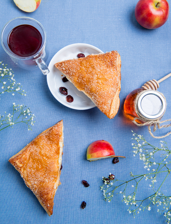 Apple turnovers served on the table covered with blue clothの写真素材