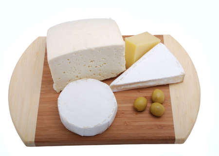 Cheeses on grocery board with oliveの写真素材