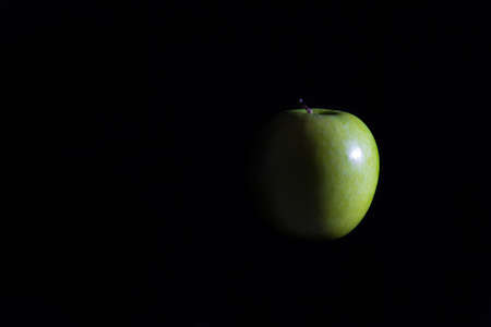 Apple on a black background.