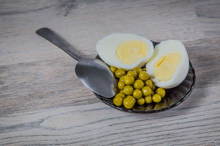 Breakfast. Egg and peas on a plateの写真素材