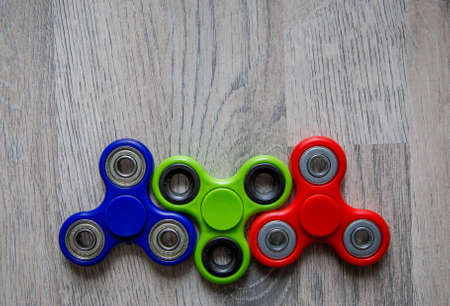 Group of fidget spinner on wooden background