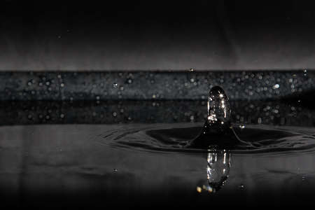 Water splash, drops isolated on black background