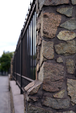 Stone Fence with Wrought Iron Details in Urban Settingの写真素材