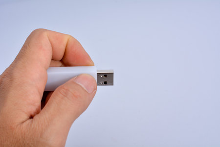 thumbdrive in  hand white backgroundの写真素材