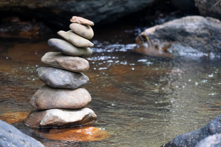 Stone stacks on waterfall in the forestの写真素材