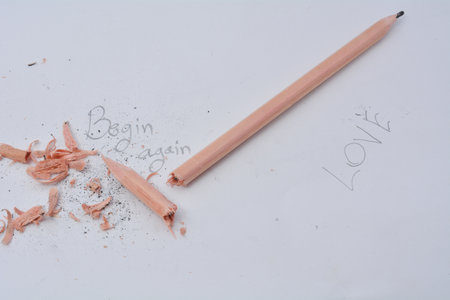 broken pencil writing with a pencil Written word begin again white backgroundの写真素材
