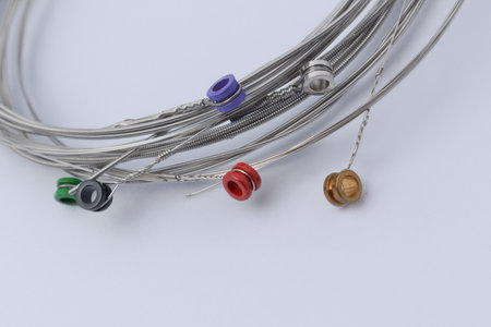 Multi-colored guitar strings white background