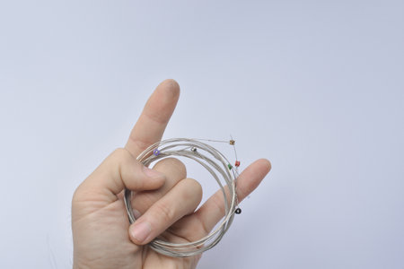 new guitar strings on guitar player , the finger of a guitarist white background