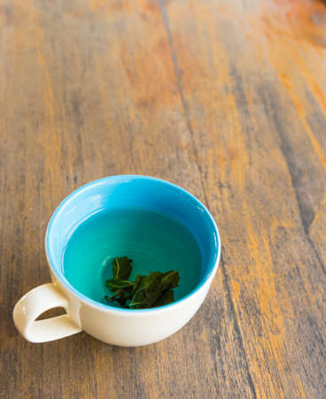 Cup of hot green tea  on wood tableの写真素材