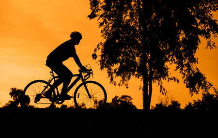 sunset silhouette of bicycleの写真素材