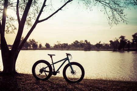 sunset silhouette of bicycle fat bikeの写真素材
