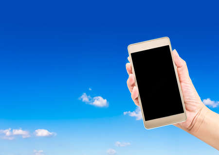 Hand holding Smartphone with blank screenの写真素材
