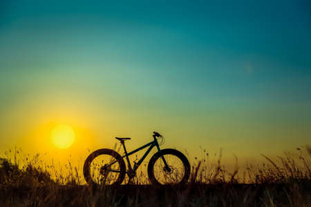 mountain bike silhouette on beautiful sunset, silhouette fatbikeの写真素材