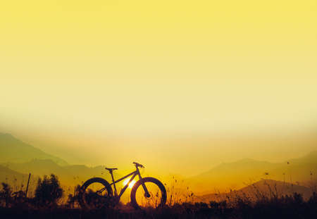 Golden sky sunset and mountain bike silhouette, silhouette fat bike, Silhouette Bicycle  on mountain backgroundの写真素材