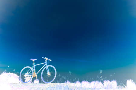Sunset silhouette and bicycle on beautiful skyの写真素材