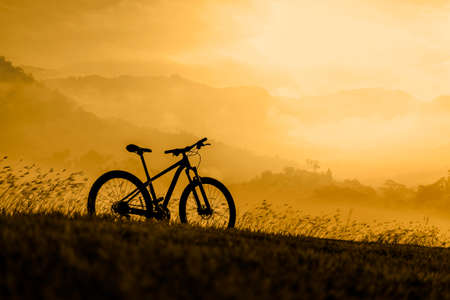 Silhouette Mountain bike on beautiful landscape, Silhouette Bicycle sunset on beautiful landscape mountain natureの写真素材