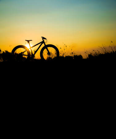 silhouette fat bike  at sunset, fat tire bike at sunsetの写真素材