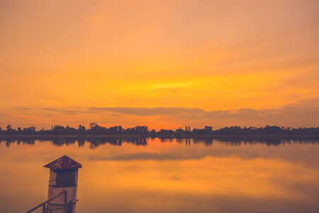 Beautiful sunset at the river, colorful clouds and water with reflectionの写真素材