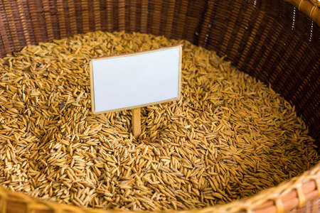 Rice seed in bamboo basket with blank labelの写真素材