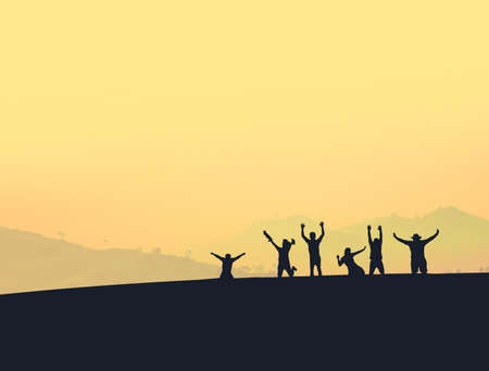 silhouette group people happy on sunsetの写真素材