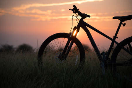 Beautiful Landscape Mountain biking down hill at sunsetの写真素材