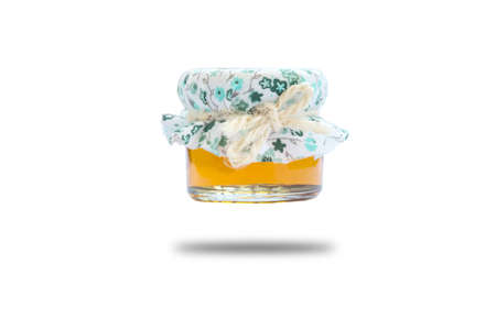 Honey in the bottle glass on white backgroundの写真素材