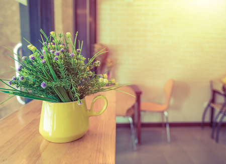 Flower decoration in Vase Yellow on Wood tableの写真素材