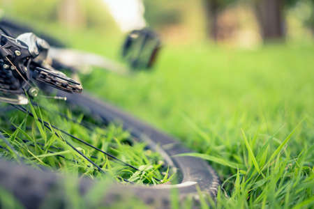 Soft focus of mountain bike on green grass backgroundの写真素材