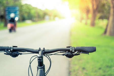 Mountain bike on blue road background at sun shineの写真素材