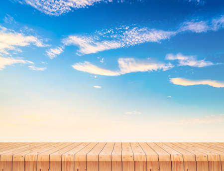 Wood table and sunset sky  for backgroundの写真素材