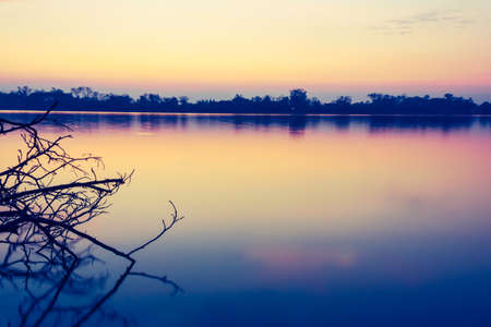 Beautiful colorful sunset on riverの写真素材