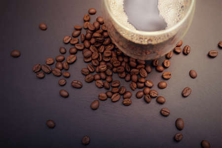 Hot coffee on wood table with coffee beansの写真素材