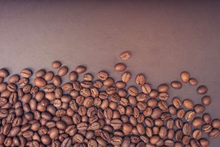 Closeup coffee beans on black woodの写真素材