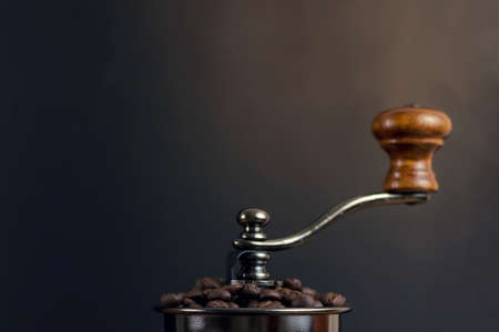 Closeup coffe beans in Coffee grinder on black backgroundの写真素材