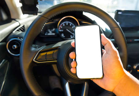 Driver in car hold blank display smartphone on hand